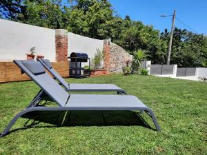 a bench sitting on the grass in a yard at Vivienda Vacacional LA PERILLANA in Avilés