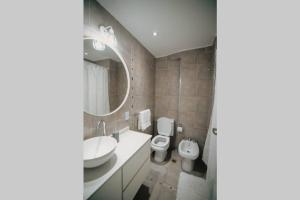 a bathroom with a sink and a toilet and a mirror at Recoleta White Home in Buenos Aires +28 photos