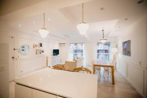 a kitchen and dining room with a table and chairs at Recoleta White Home in Buenos Aires