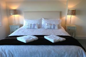 a bedroom with a bed with two towels on it at Bassets House in Eastbourne