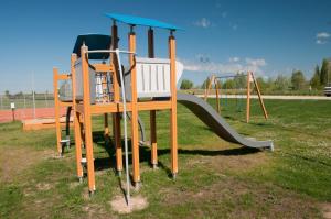 a playground with a slide in a park at Ūdens Tūrisma Attīstības Centrs Bāka in Gaigalava