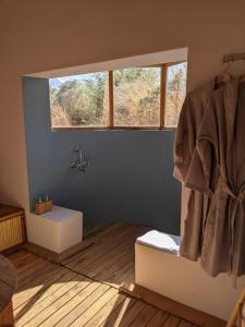 a bathroom with a sink and a window at The Indus River Camp in Leh +90 photos