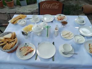 a white table with plates of food on it at Hotel Beni in Akhaltsikhe