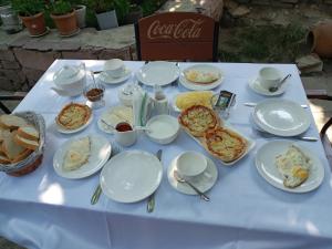 a white table with plates of food on it at Hotel Beni in Akhaltsikhe