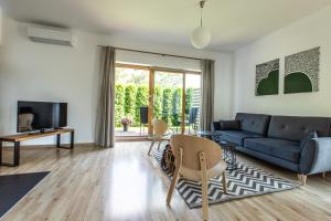a living room with a couch and a tv at Aušra in Druskininkai