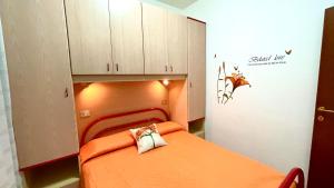 a bedroom with a bed with an orange blanket at Belvedere Home in Rodi Garganico