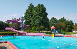 a pool with a water slide in a park at 3 Bedroom Nice Home In Heinkenszand in Heinkensand
