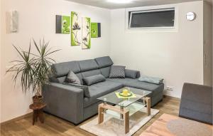 a living room with a couch and a table at Nice Apartment In Dortstetten With 1 Bedrooms And Wifi in Dorfstetten