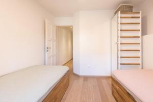a bedroom with two beds and a staircase at Romantic stone house in historic center of Vrbnik in Vrbnik