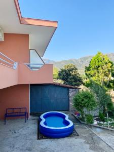 a large blue pool sitting outside of a house at Shuko Village House in Sarandë