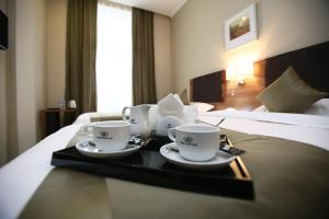 Postel nebo postele na pokoji v ubytování Tskaltubo Plaza Hotel