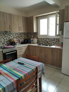 een keuken met een tafel en een koelkast bij ASTERIA HOUSE in Kala Nera