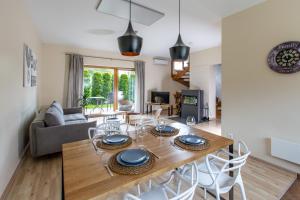 a dining room and living room with a table and chairs at Aušra in Druskininkai