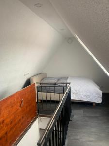 a bedroom with a bed in a attic at Ferienwohnung Wilflingen in Langenenslingen