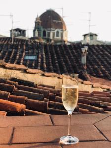 ein Glas Wein auf dem Dach in der Unterkunft TRAVIATA APPARTAMENTO STORICO - PALAZZO TOLOMEI in Florenz