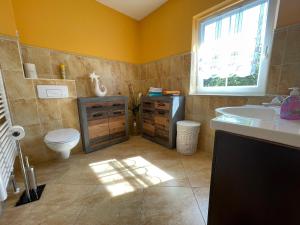 a bathroom with a toilet and a sink and a window at Zentrumsnahe Ferienwohnung in Dresden +18 photos
