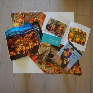 a table topped with books and pictures on it at Nomadi Sedentari - Irsina in Irsina