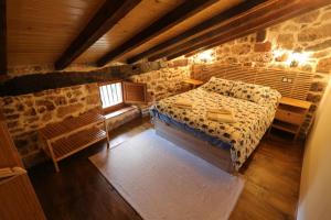 a bedroom with a bed and a window in a building at El Salto del Agua in Orbaneja del Castillo