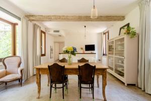 a dining room with a wooden table and chairs at Melusina Homes in Venice