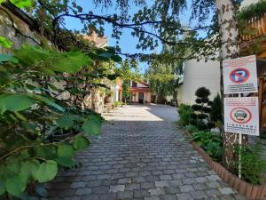 a cobblestone street with signs on the side at Korona Panzió in Odorheiu Secuiesc