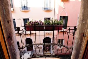 un balcone con un vaso con fiori di Charming canal view San Marco apartment a Venezia