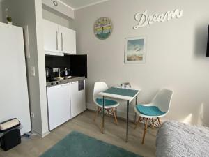 a small kitchen with a table and chairs in a room at Business Appartement Mainz in Mainz