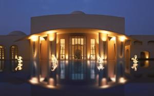 a building with lights in front of it at night at Trident Gurgaon in Gurgaon