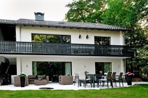 a house with a deck and a patio at Haus Orbis Noster im Harz - Whirlpool und Sauna - direkt am Wald in Bad Grund