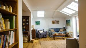 a living room with a blue couch and a book shelf at The Haven in Sheringham