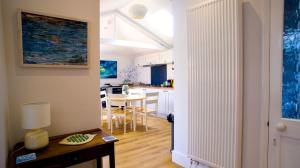 a kitchen and living room with a table and a dining room at The Haven in Sheringham