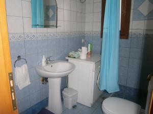 a small bathroom with a sink and a toilet at Moraki Apartment in Episkopión +18 photos