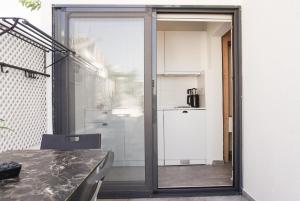 a glass door leading into a kitchen with a table at Daphnis Hotel in Golturkbuku