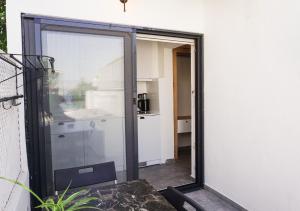 a sliding glass door leading into a kitchen at Daphnis Hotel in Golturkbuku