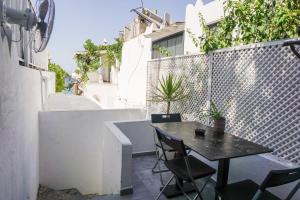 a patio with a table and chairs on a balcony at Daphnis Hotel in Golturkbuku