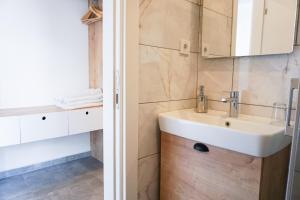 a bathroom with a sink and a mirror at Daphnis Hotel in Golturkbuku