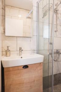 a bathroom with a sink and a shower at Daphnis Hotel in Golturkbuku