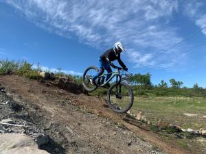 a person riding a bike on a dirt road at Ramsbu utsikt terasse selvhushold in Hovden