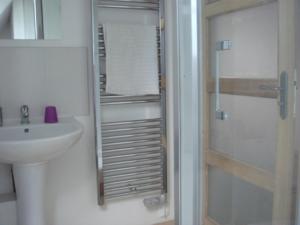 a small bathroom with a sink and a shower at Captivating 2-Bed House with log burner in Kerien in Kérien +28 photos