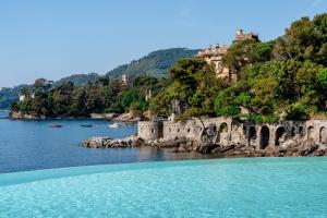 a view of a body of water with a castle on a hill at Excelsior Palace Portofino Coast in Rapallo