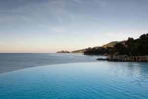 a large pool of water next to the ocean at Excelsior Palace Portofino Coast in Rapallo