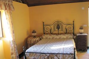 a bedroom with a bed in a yellow room at Casinha de Xisto - Serra do Açor in Benfeita +17 photos