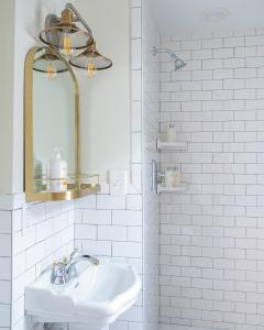 a white bathroom with a sink and a mirror at Sally Webster Inn in Rockport