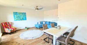 a living room with a table and chairs and a couch at Sanosueno 4 in Sonthofen