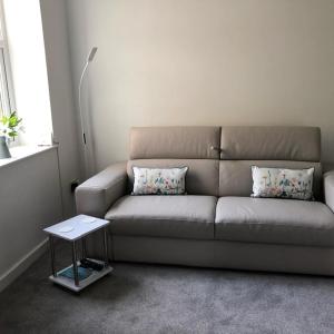 a living room with a couch and a table at Flat 2 Frank Lewis House in Hay-on-Wye