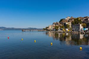 a large body of water with yellow balls in it at Camping Vigna di Valle in Anguillara Sabazia