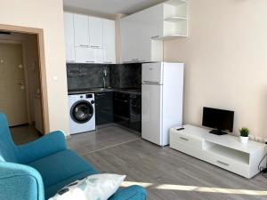 una cucina con frigorifero e lavatrice di Mountain View Magenta White apartment a Sofia