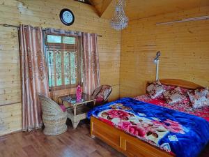 a bedroom with a bed and a table and a clock at Beautiful View Homestay in Darjeeling