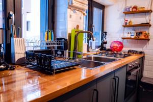 a kitchen counter with a dish drying rack next to a sink at Dream House in Buşteni