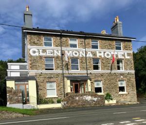 an old brick building with a sign on it at The Glen Mona Hotel in Maughold