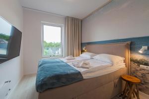 Łóżko lub łóżka w pokoju w obiekcie Mi Casa Holidays Apartamenty Olimpijska O2